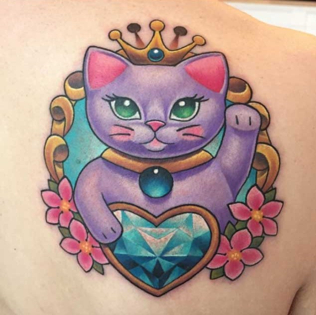 Cute cartoon like colored kitty portrait tattoo on shoulder stylized with diamond