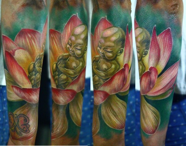 Cute cartoon style colored forearm tattoo of small Buddha statue with lotus flower