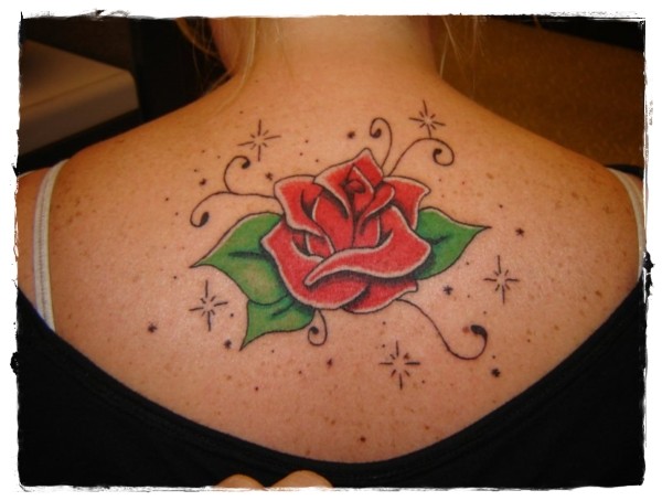 Cute cartoon style painted and colored rose tattoo on upper back