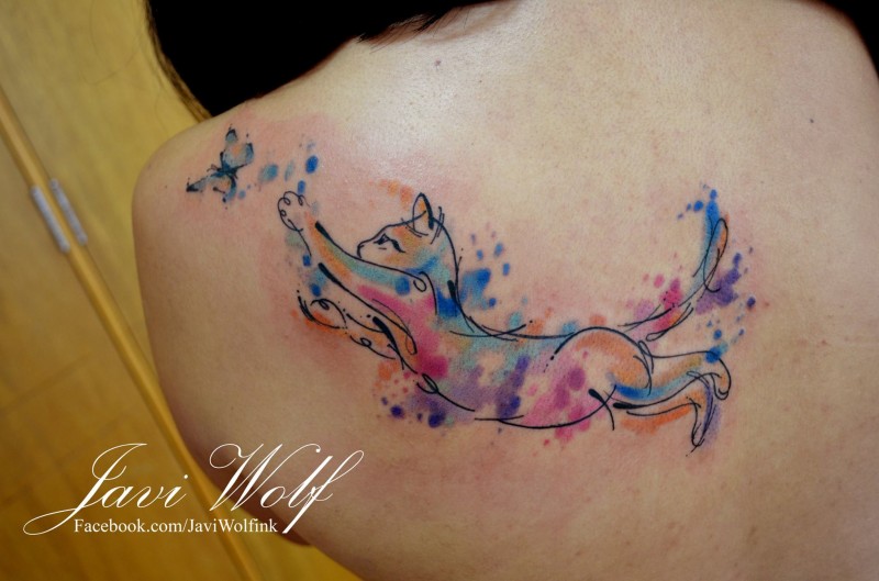 Cute cat catching butterfly colored back tattoo by Javi Wolf in watercolor style