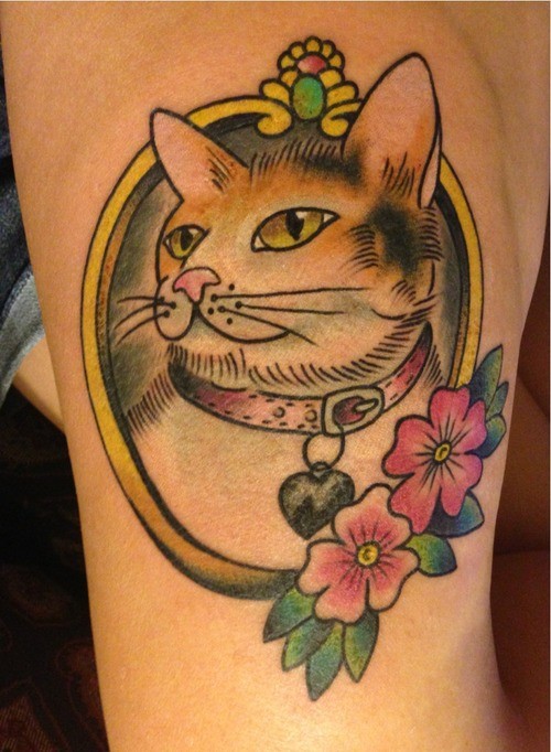 Cute cat with collar in frame with pink flower tattoo in old school style