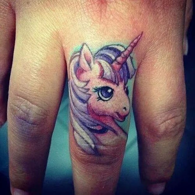 Cute girl unicorn cartoon colored tattoo on finger
