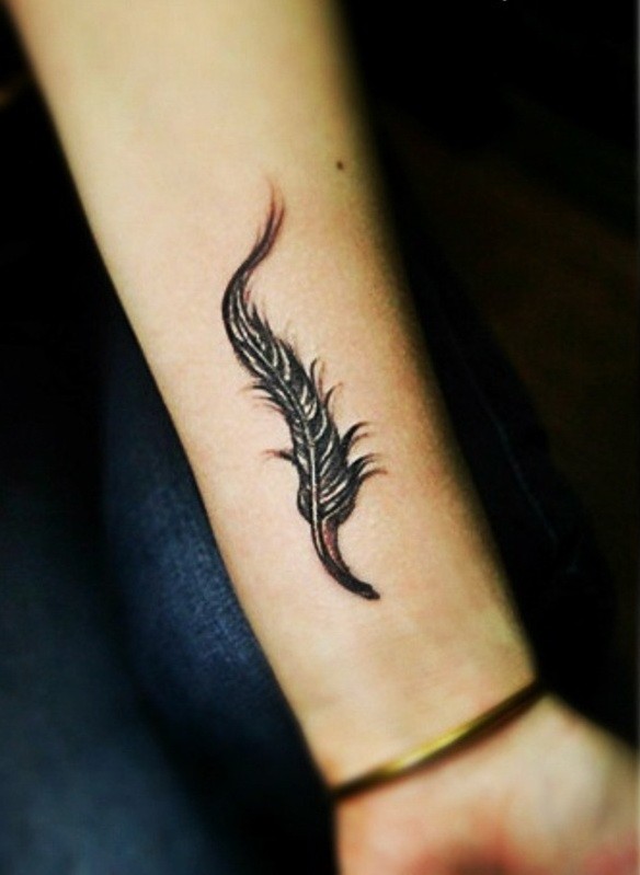 Cute gray-ink feather tattoo on forearm