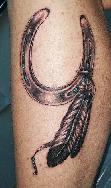 Cute horseshoe for good luck and feathers tattoo