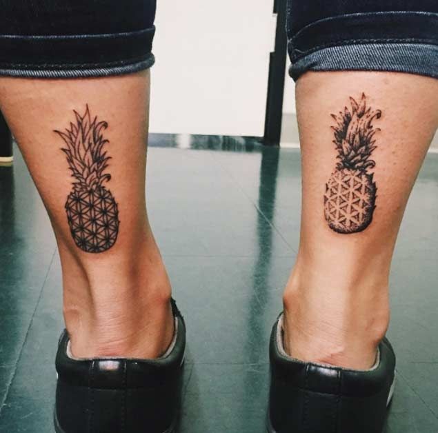 Cute identical looking black ink pineapples tattoo on ankles