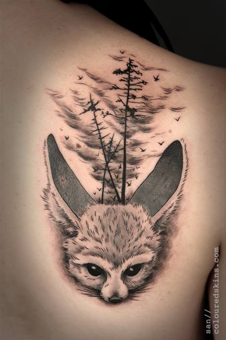 Cute illustrative style scapular tattoo of wild animal with forest