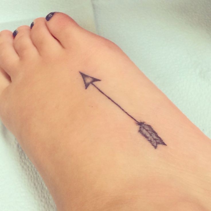 Cute little black arrow tattoo on girls leg