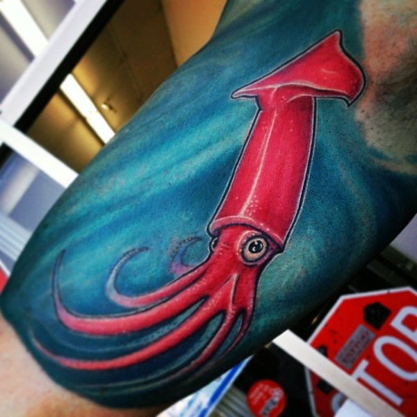 Cute little cartoon like red squid tattoo on biceps