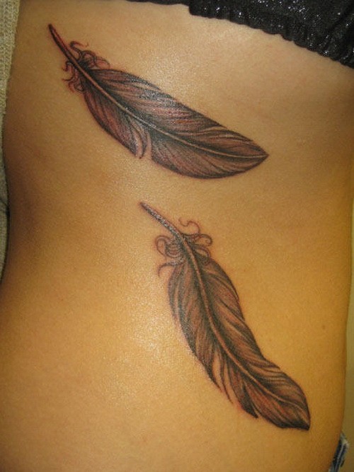 Cute little gray-ink feathers tattoo on back