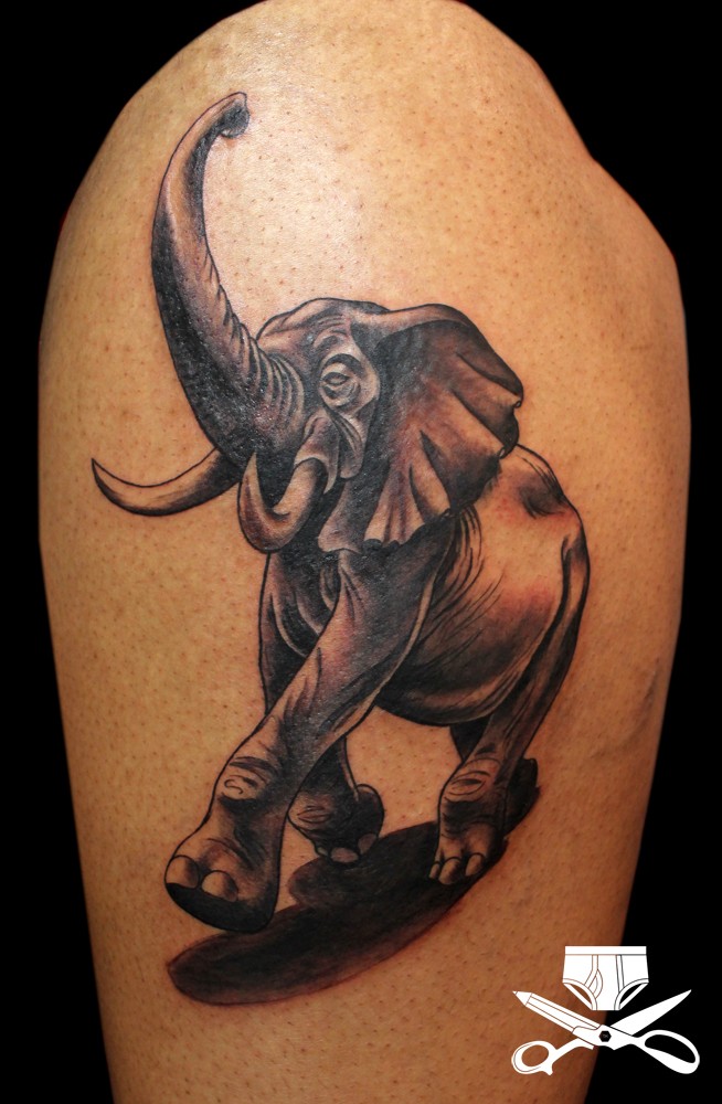 Cute looking colored cartoon style tattoo of walking elephant