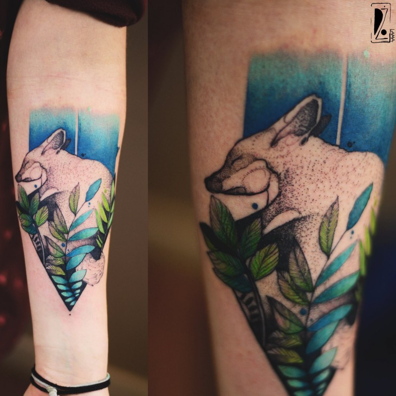 Cute looking colored forearm tattoo of sleeping fox with leaves