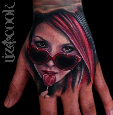 Cute looking colored hand tattoo of woman with lollipop