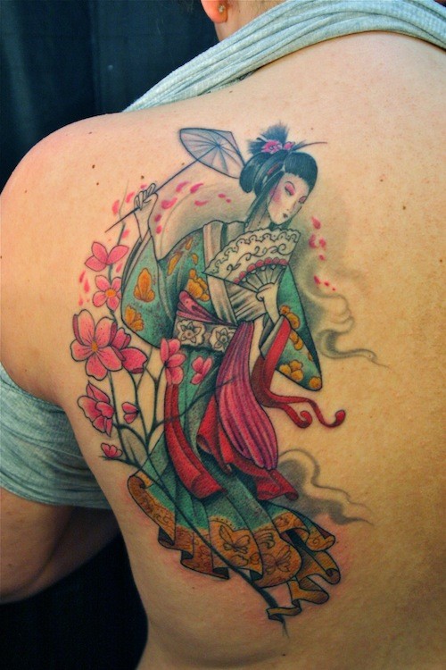 Cute looking colored scapular tattoo of geisha with flowers