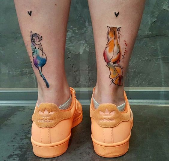 Cute new school style colored legs tattoo of cats with hearts