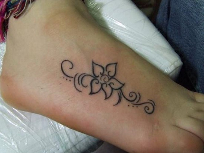 Cute simple gray-ink flower tattoo on foot