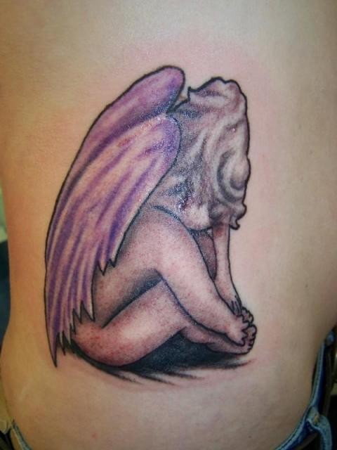 Cute sorrowful cherub tattoo
