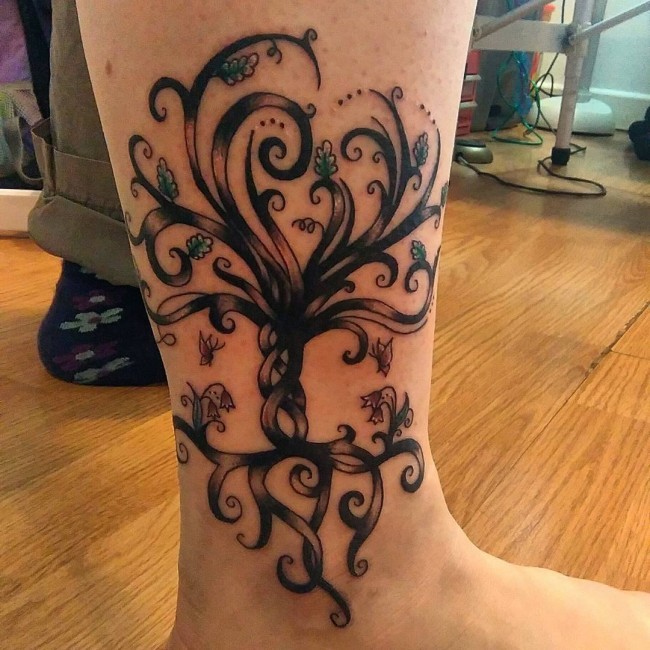 Cute tiny colored fantasy tree tattoo on ankle with flowers