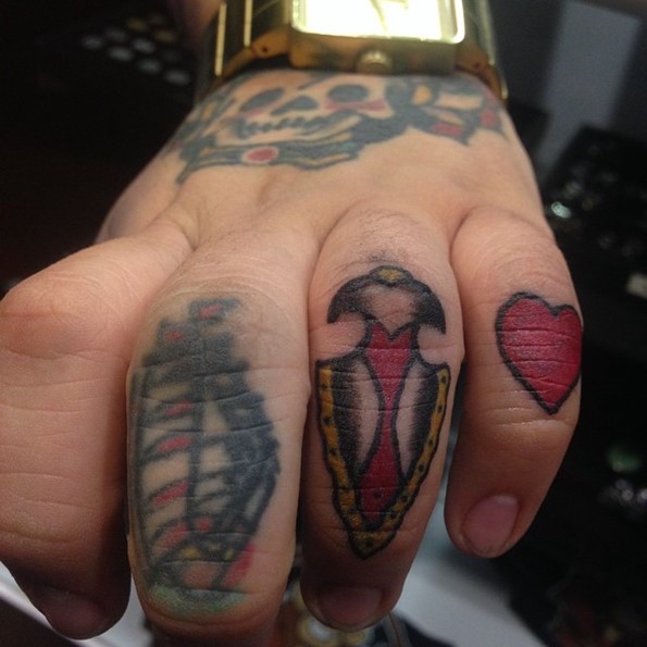 Cute tiny old school finger tattoo of ancient weapon
