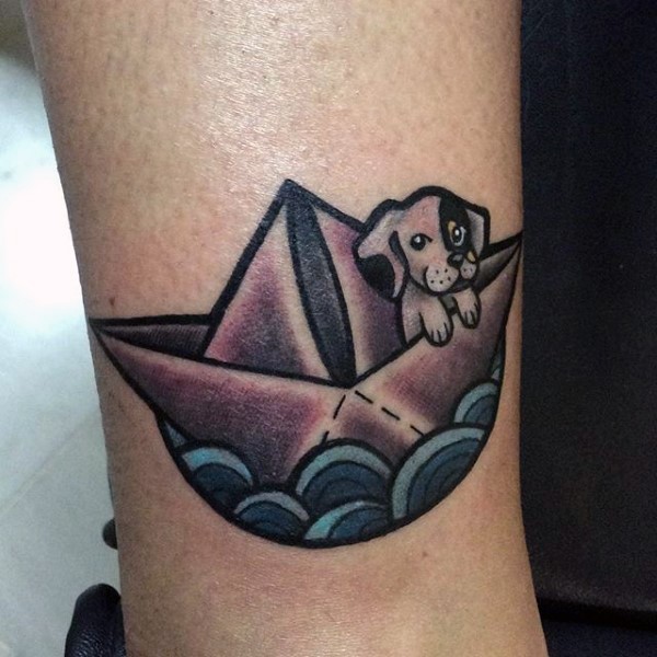 Cute tiny puppy swimming in paper ship colored detailed tattoo