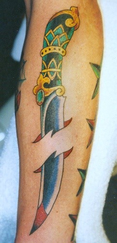Dagger pierced skin forearm tattoo