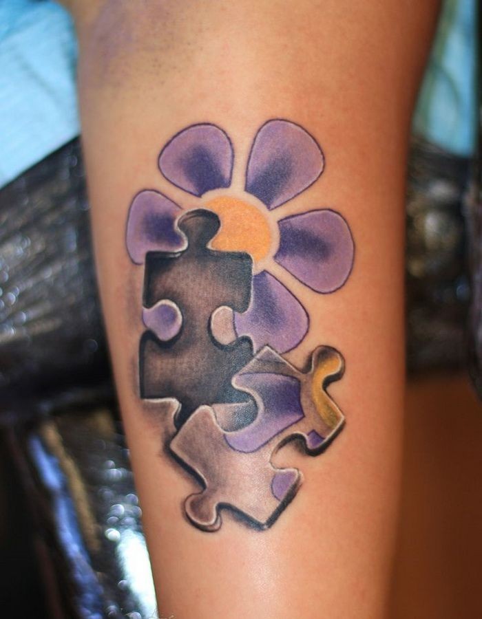 Daisy puzzle tattoo on arm