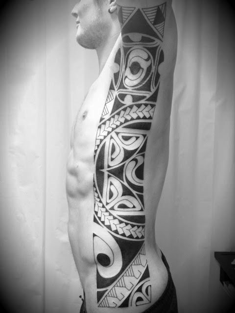 Dark black and white tribal style tattoo on side
