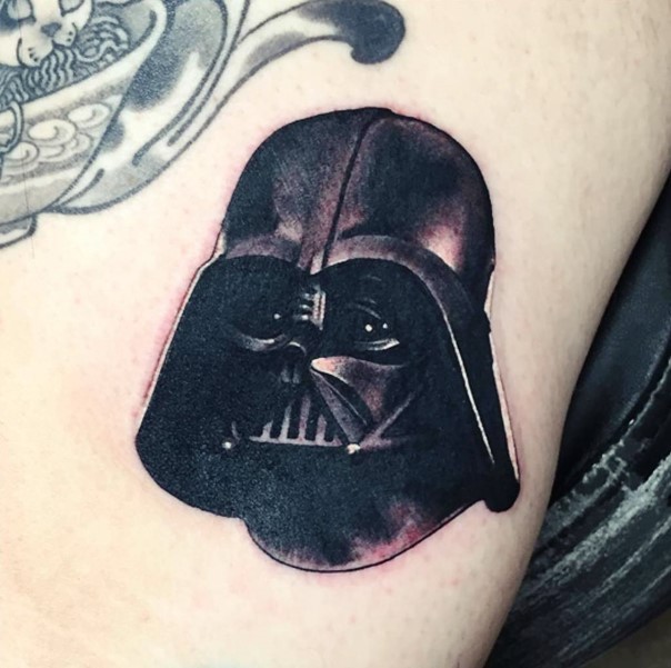 Dark black detailed true to life tattoo of Darth Vader's helmet