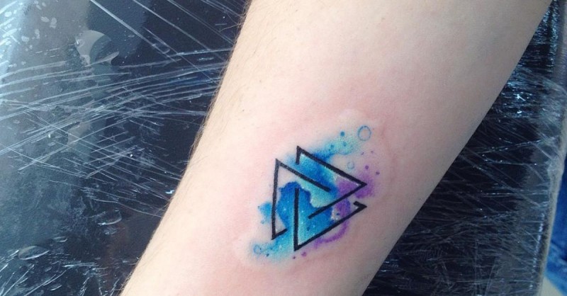 Dark black ink connected triangles colored tattoo in watercolor style
