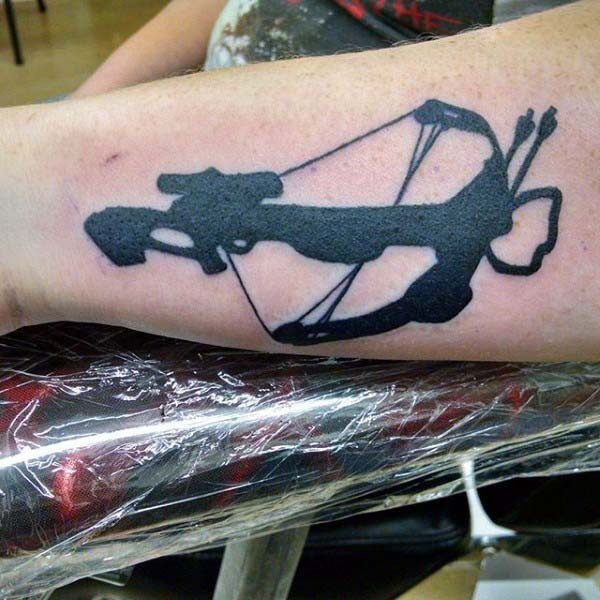 Dark black ink detailed crossbow tattoo