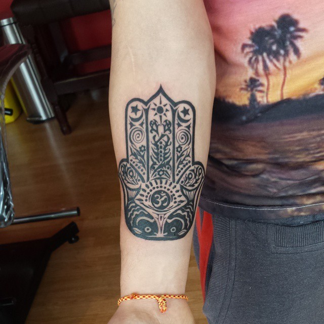 Dark black ink Hamesh hand forearm tattoo with original ornament and special symbols