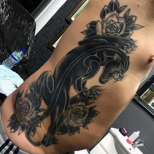 Dark colored old school style black panther and rose flowers side tattoo