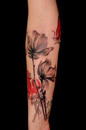Dark poppies tattoo on arm