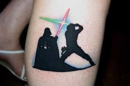 Dart Vader fighting on light saber colored leg tattoo Star Wars themed
