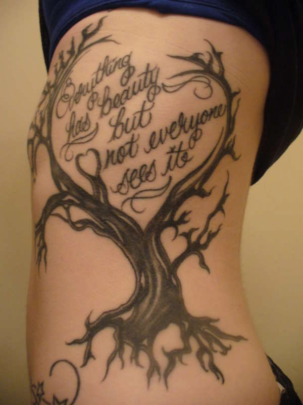 Tatuaje en las costillas,
árbol seco y inscripción