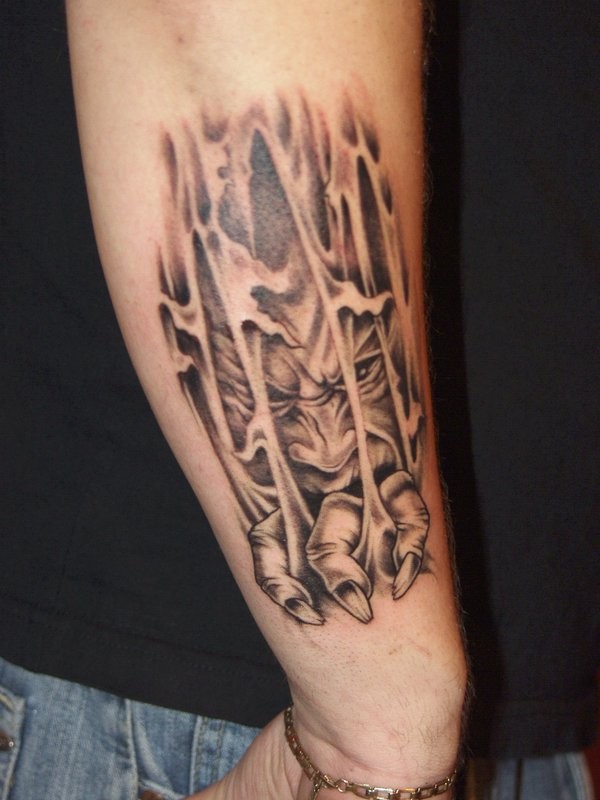 Demon climbs out through skin tattoo on forearm by fiesta