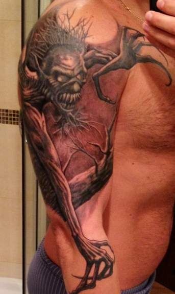 Demon with long arms tattoo on half sleeve