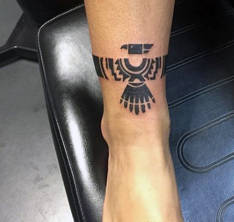 Desert tribes themed black ink ankle tattoo of eagle shaped painting