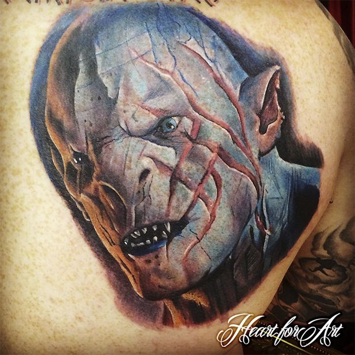 Detailed and colored scapular tattoo of orc face