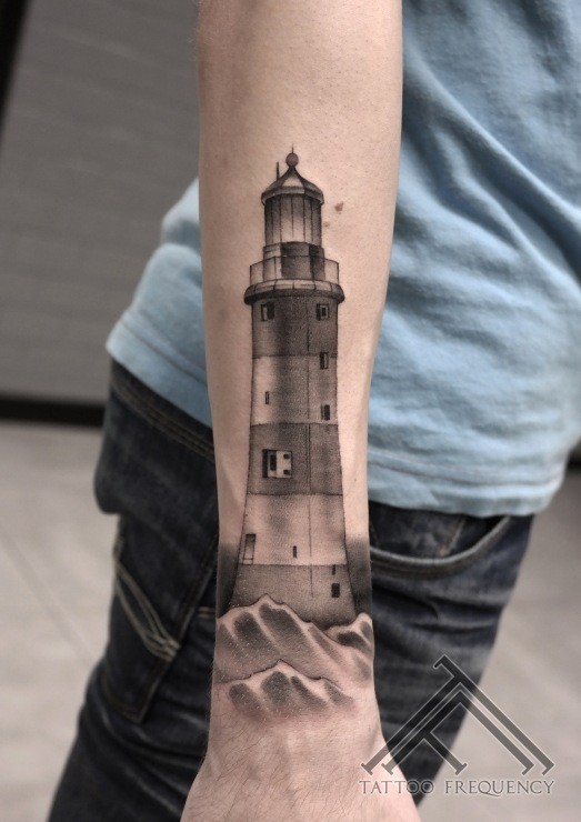Detailed black ink arm tattoo of lighthouse