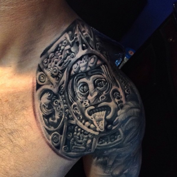Detailed black ink shoulder tattoo of Aztec tablet