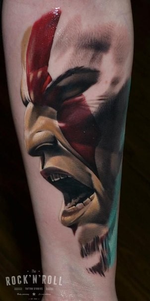 Detailed colored forearm tattoo of screaming barbarian