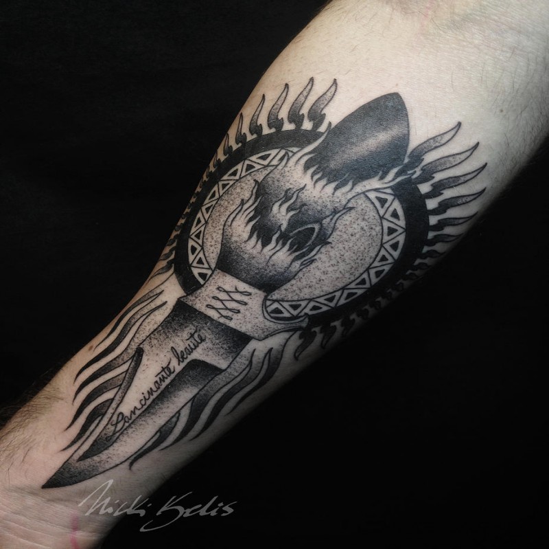 Detailed engraving style forearm tattoo of demonic knife with lettering and sun
