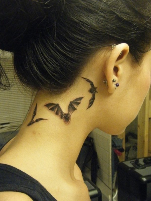 Detailed flying bats small size tattoo on lady&quots neck