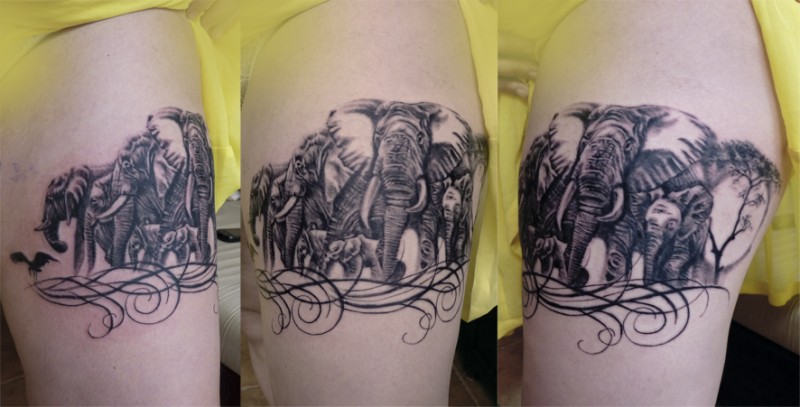 Detailed looking black ink shoulder tattoo of big elephant family