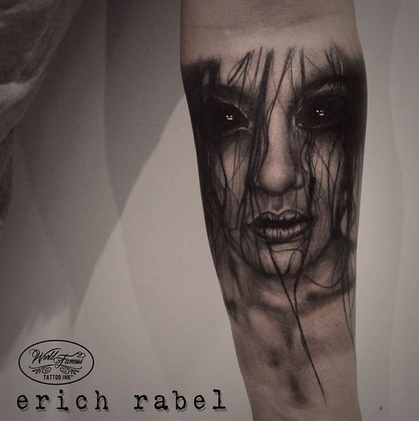 Detailed mystical looking forearm tattoo of demonic woman face