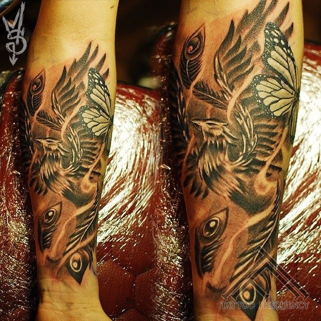 Detailed painted and colored big phoenix with butterfly tattoo on arm