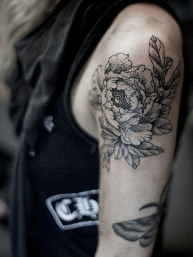 Detailed peony flower black and white tattoo on upper arm