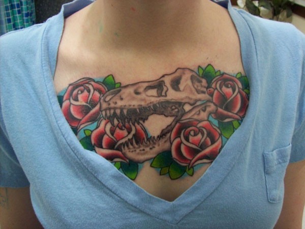 Dinosaur skull and red roses chest tattoo