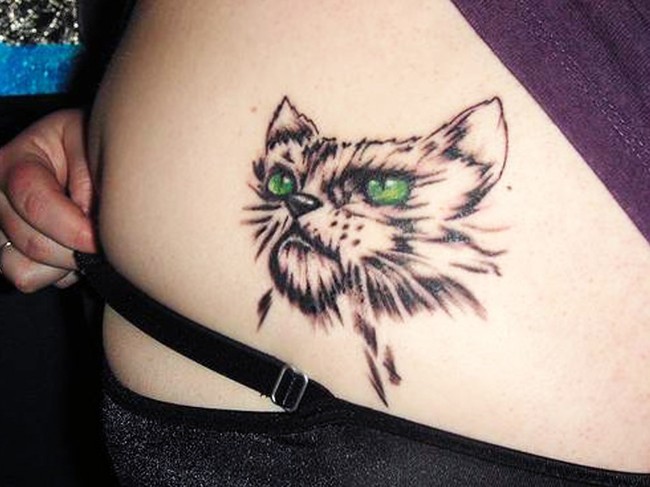 Dissatisfied cat with green eyes tattoo