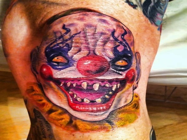 Distasteful colorful clown tattoo on arm